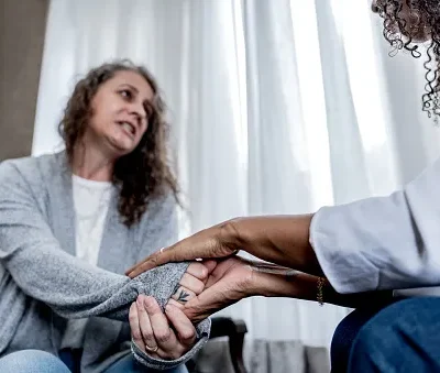 depressed woman talking to therapist at her home