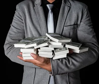 man holding money in hand at black background man receive a lot money from trading business