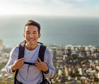 portrait of hiker smiling against sea